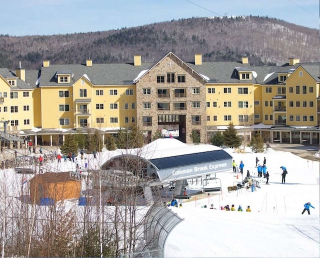 snowy aerial view featuring a mountain view