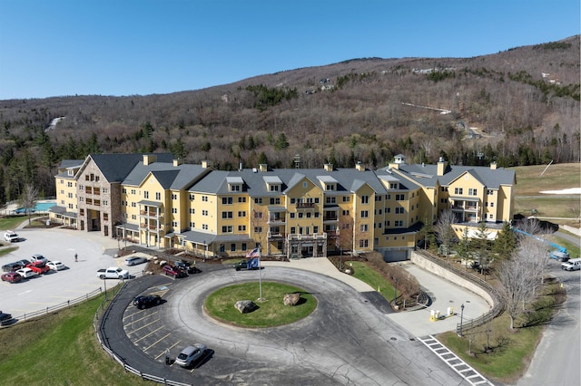 aerial view with a wooded view and a mountain view