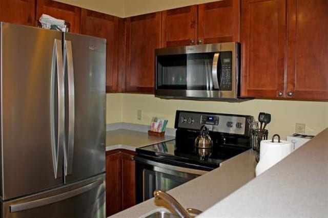 kitchen featuring light countertops and appliances with stainless steel finishes