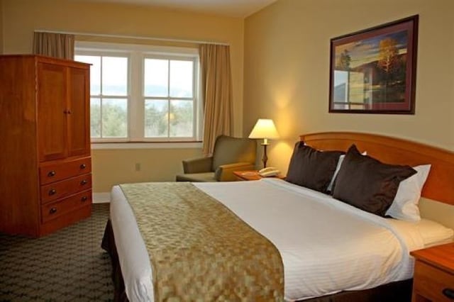 bedroom with dark colored carpet