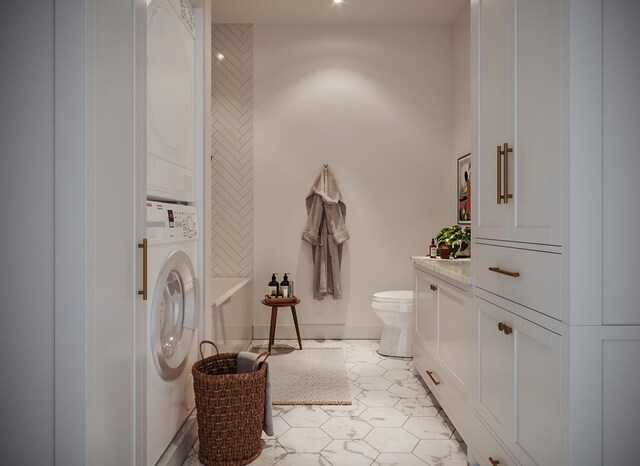 laundry area with light tile flooring and stacked washer and dryer