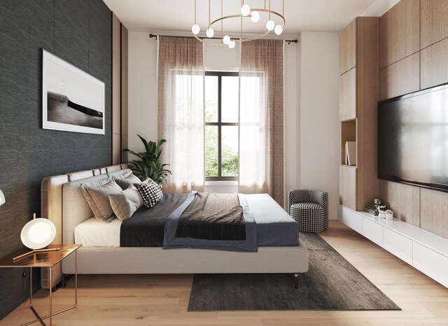 bedroom with light wood-type flooring and a chandelier