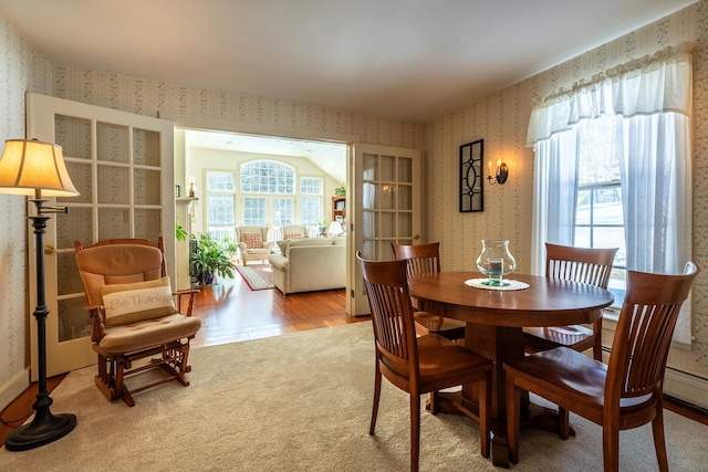 carpeted dining room featuring a wealth of natural light