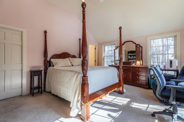 bedroom featuring light carpet and vaulted ceiling