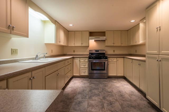 kitchen featuring gas stove and sink