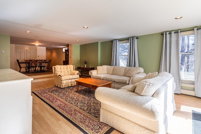 living room with a wealth of natural light and light hardwood / wood-style floors