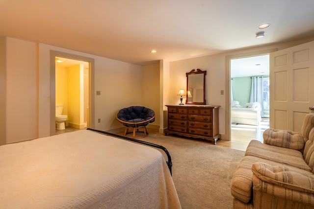 carpeted bedroom featuring ensuite bath