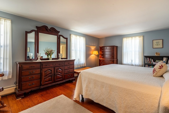 bedroom with dark wood-type flooring and multiple windows