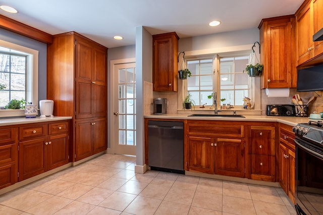 kitchen with black appliances, backsplash, light tile patterned floors, and sink