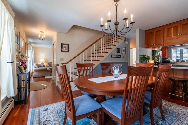 dining space with dark hardwood / wood-style floors, an inviting chandelier, and baseboard heating