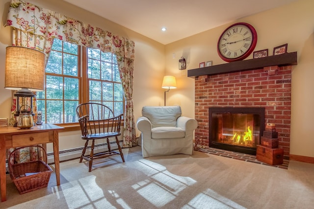 living area with a brick fireplace, light carpet, and a baseboard heating unit