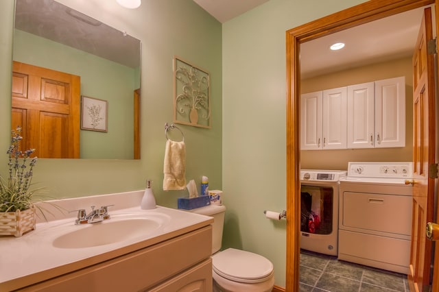 bathroom featuring oversized vanity, tile floors, toilet, and washing machine and clothes dryer