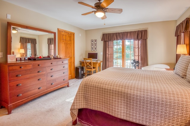 bedroom featuring light colored carpet, ceiling fan, and access to exterior