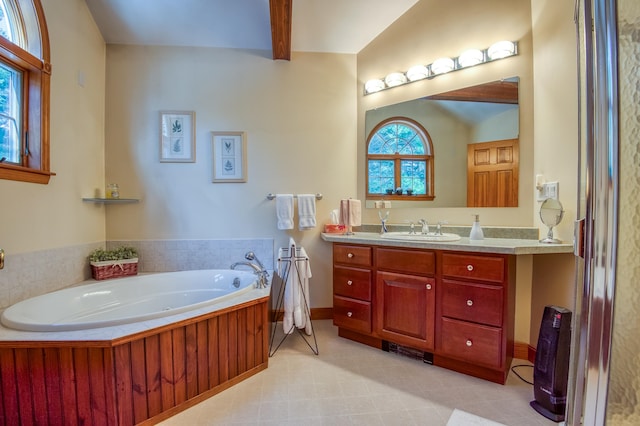 bathroom with oversized vanity, tile floors, beam ceiling, and a bath to relax in