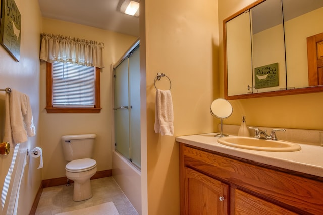 full bathroom with toilet, tile floors, vanity, and shower / bath combination with glass door