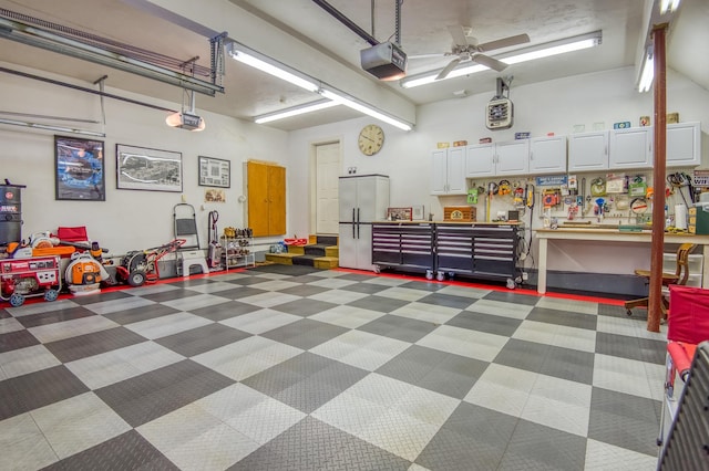 garage with ceiling fan, a garage door opener, and a workshop area