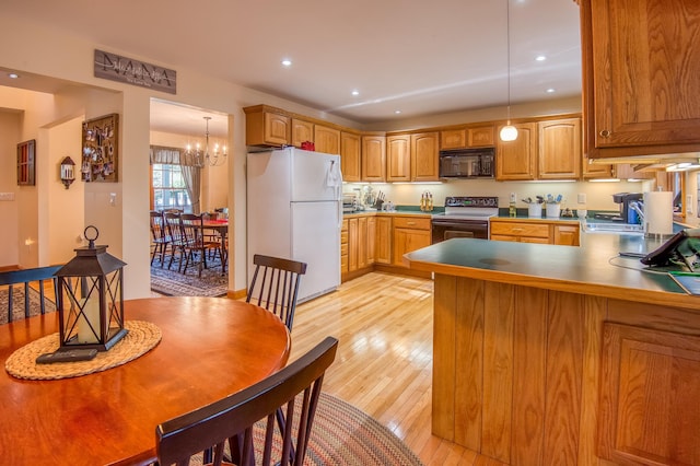 kitchen featuring white fridge, electric stove, pendant lighting, light wood-type flooring, and a chandelier