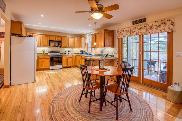 dining area with light hardwood / wood-style flooring, ceiling fan, and sink