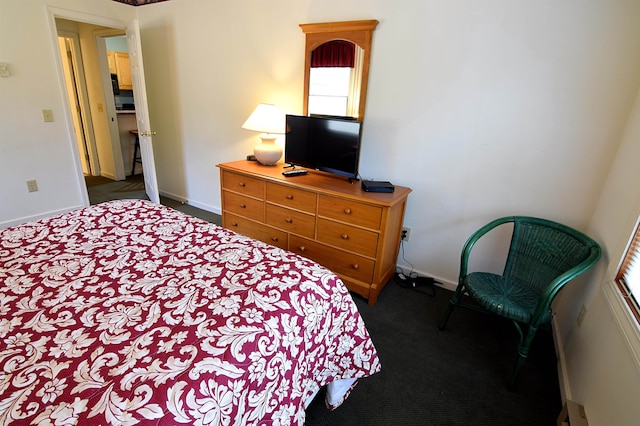 carpeted bedroom featuring a baseboard radiator