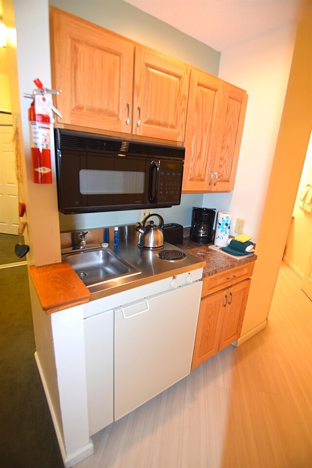 kitchen with sink and light hardwood / wood-style flooring