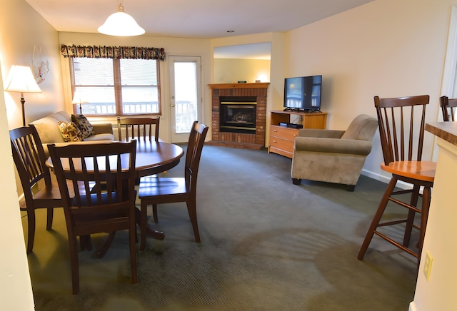 carpeted dining room featuring a brick fireplace