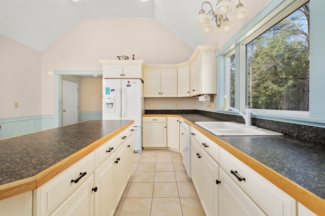 kitchen with white appliances, an inviting chandelier, sink, light tile floors, and lofted ceiling