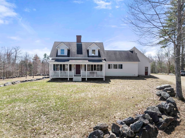 new england style home with a front lawn and a porch