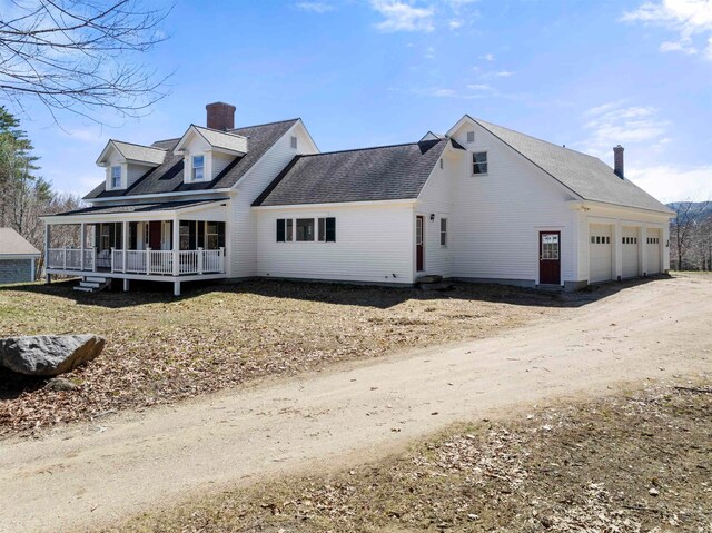 exterior space featuring a garage and covered porch