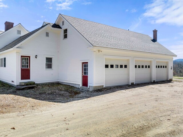view of side of home with a garage