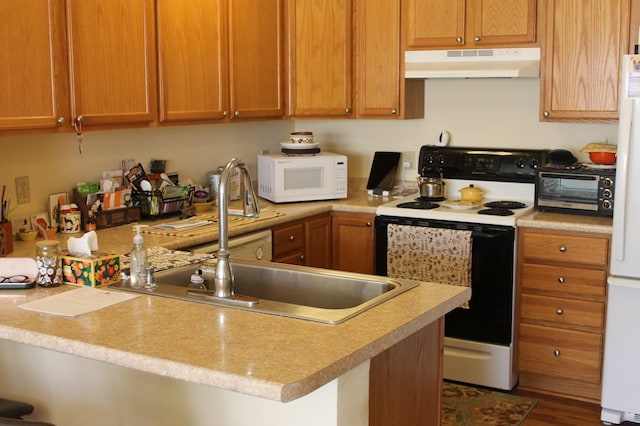 kitchen with white appliances and hardwood / wood-style floors