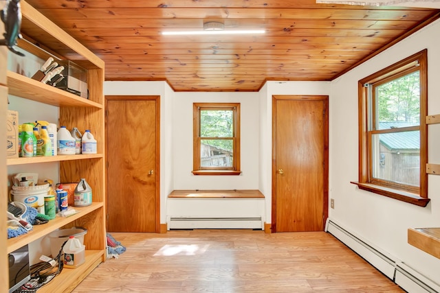 interior space featuring wood ceiling, light wood-type flooring, and baseboard heating