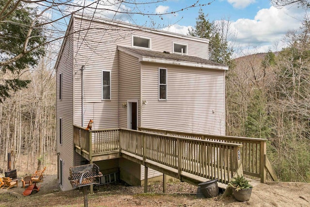 rear view of property featuring a deck