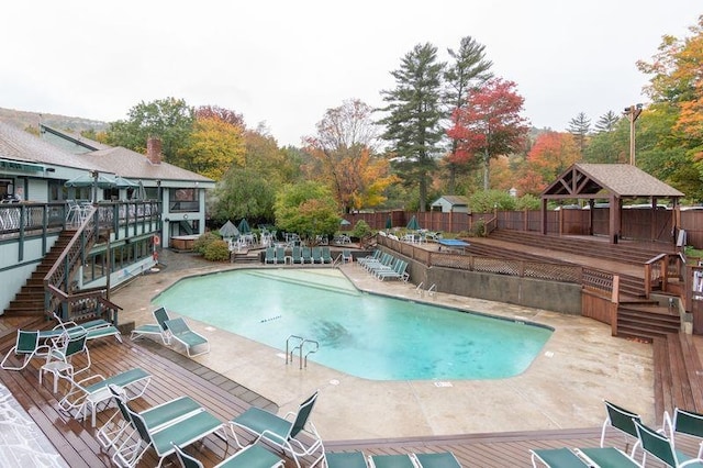 view of swimming pool with a patio, a wooden deck, and a gazebo