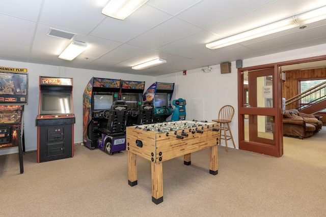 recreation room with a drop ceiling and carpet