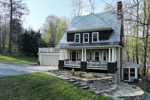 view of front facade with a garage, central air condition unit, and covered porch