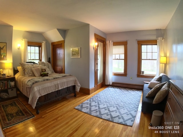 bedroom featuring multiple windows and light hardwood / wood-style flooring