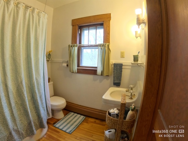 bathroom with sink, toilet, and wood-type flooring