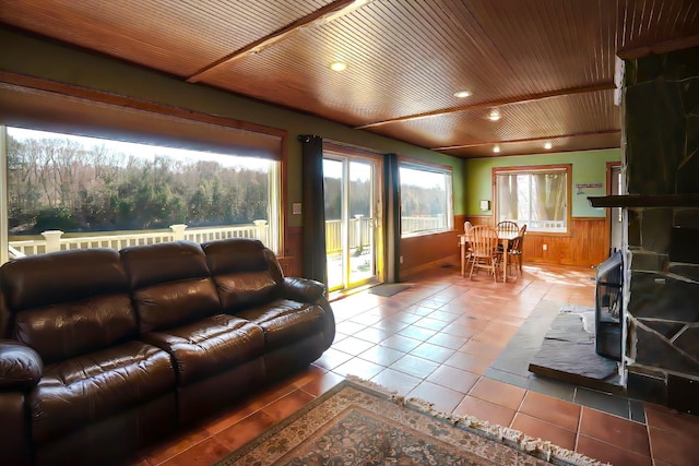 tiled living room featuring wood walls and wood ceiling