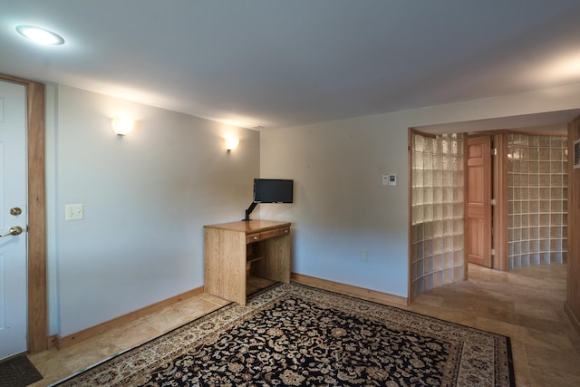 interior space with tile patterned floors and baseboards