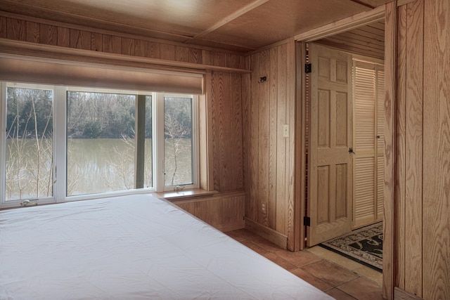 unfurnished bedroom featuring wooden walls and wooden ceiling