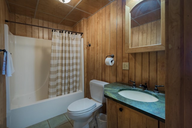 full bathroom featuring tile patterned flooring, vanity, shower / tub combo, toilet, and wood walls