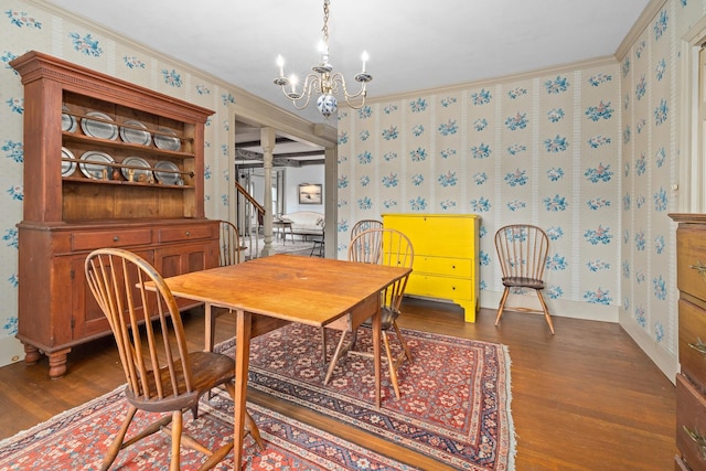 dining area with a chandelier, crown molding, and dark hardwood / wood-style flooring