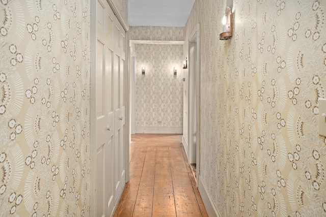 hallway with hardwood / wood-style flooring