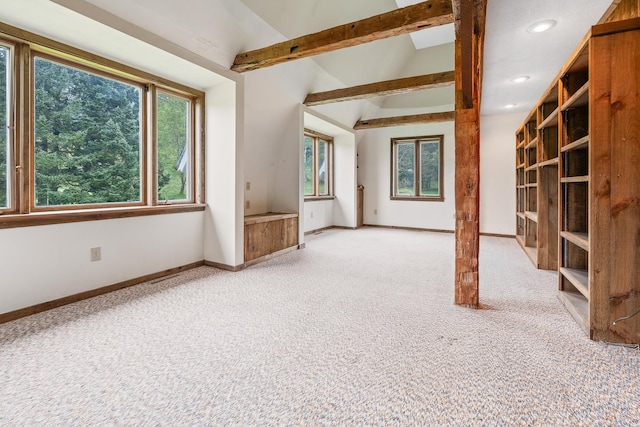 unfurnished living room with lofted ceiling with beams and carpet