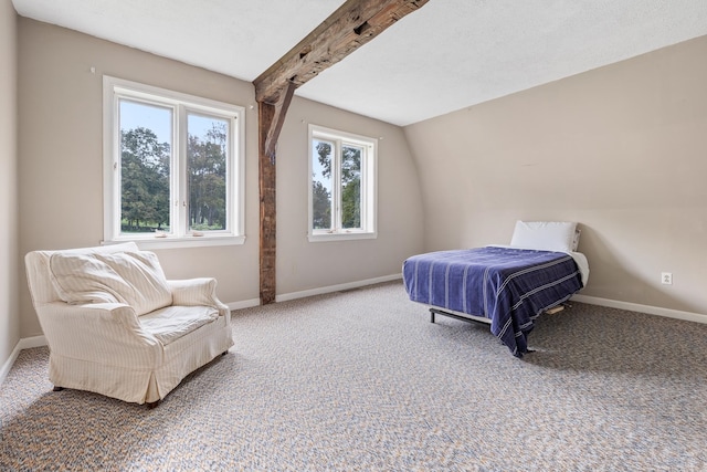 bedroom with vaulted ceiling with beams, carpet floors, and a textured ceiling