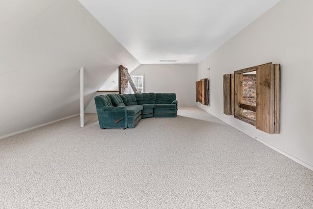 carpeted living room featuring vaulted ceiling