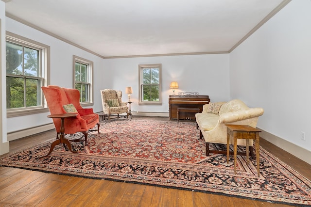 sitting room with crown molding, hardwood / wood-style flooring, and baseboard heating