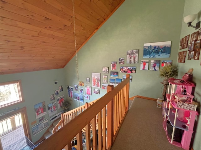 recreation room featuring carpet floors, high vaulted ceiling, and wooden ceiling