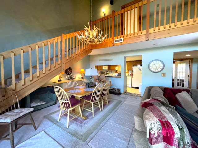 dining area featuring a high ceiling and a chandelier