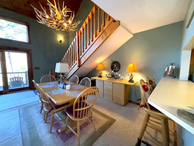 dining area featuring lofted ceiling and an inviting chandelier